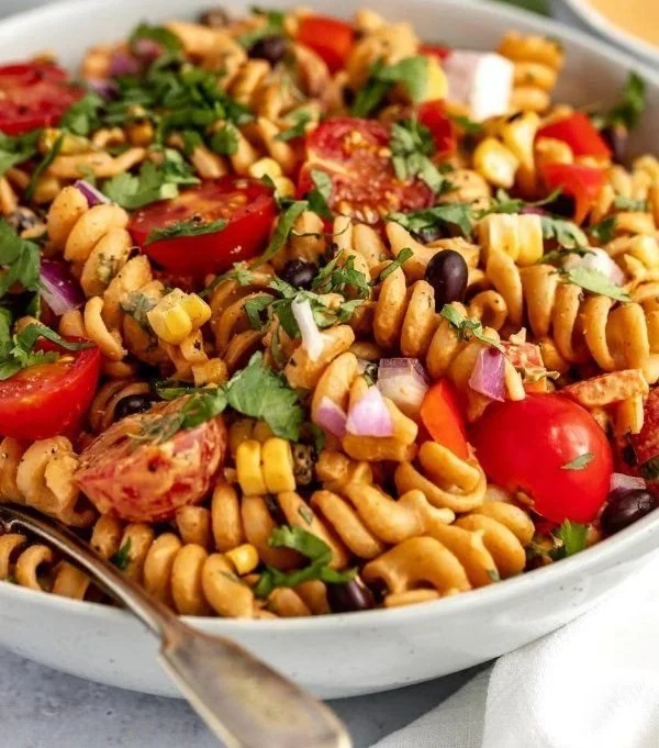 Vegan Southwest Pasta Salad with fresh veggies and spices in a bowl.